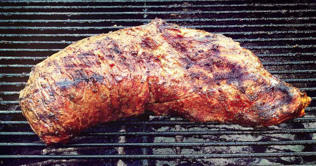 BBQ tri tip roast cooking on a charcoal grill